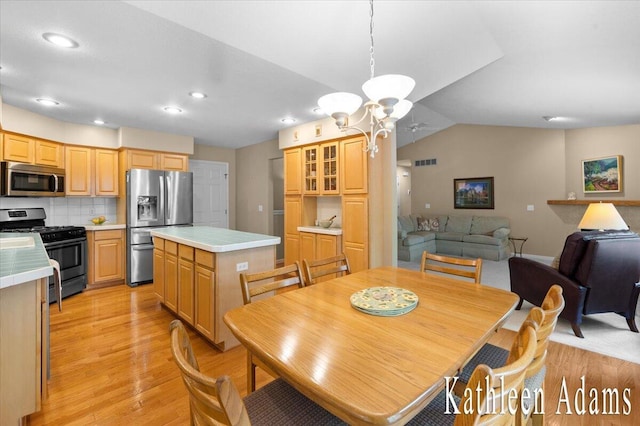 9650 Killdeer Ct, Canadian Lakes, MI 49346 - dining area featuring light wood-type flooring, recessed lighting, a chandelier, and vaulted ceiling