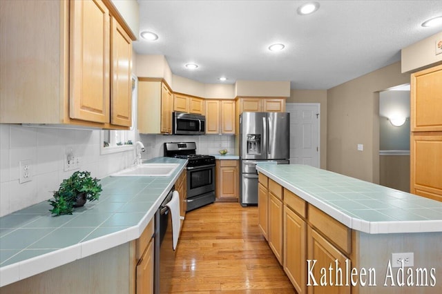 9650 Killdeer Ct, Canadian Lakes, MI 49346 - kitchen featuring stainless steel appliances, tile counters, light brown cabinetry, decorative backsplash, and recessed lighting
