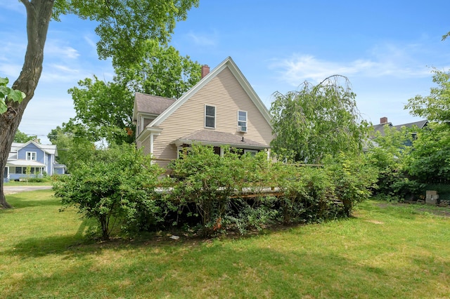 1310 Washington Ave, Kalamazoo, MI 49001 - view of home's exterior featuring a yard, a chimney, and a shingled roof