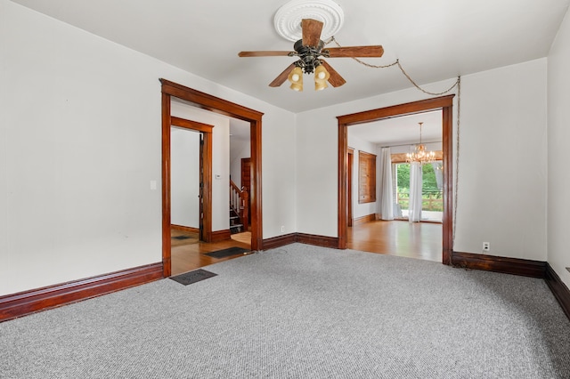 1310 Washington Ave, Kalamazoo, MI 49001 - carpeted empty room featuring a chandelier, stairway, and a ceiling fan