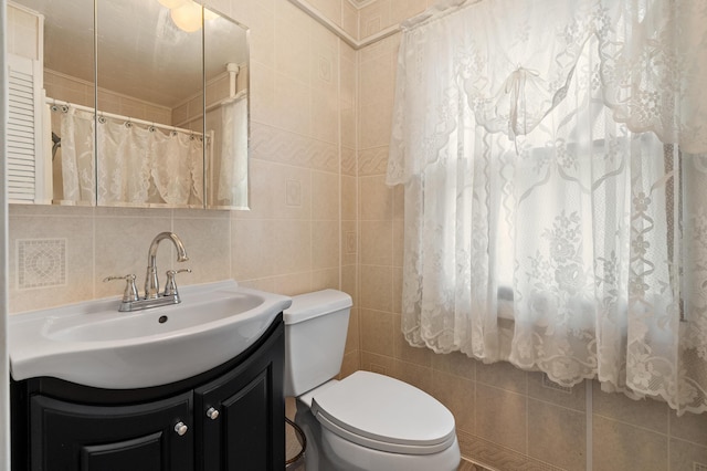1310 Washington Ave, Kalamazoo, MI 49001 - bathroom featuring tile walls, vanity, and a shower with shower curtain