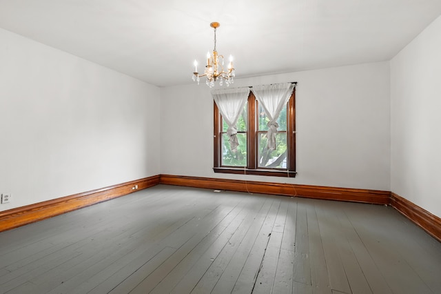 1310 Washington Ave, Kalamazoo, MI 49001 - unfurnished room featuring a chandelier and wood-type flooring