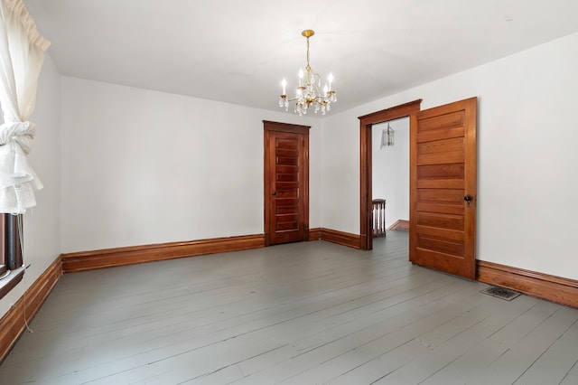 1310 Washington Ave, Kalamazoo, MI 49001 - empty room featuring a chandelier and wood finished floors