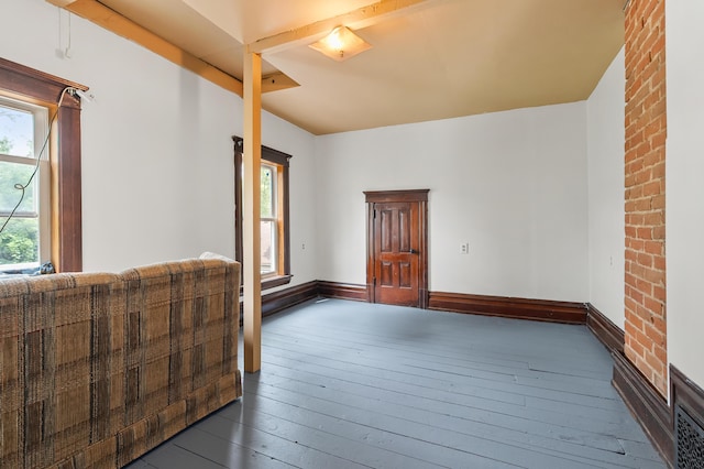 1310 Washington Ave, Kalamazoo, MI 49001 - spare room with dark wood-type flooring and baseboards