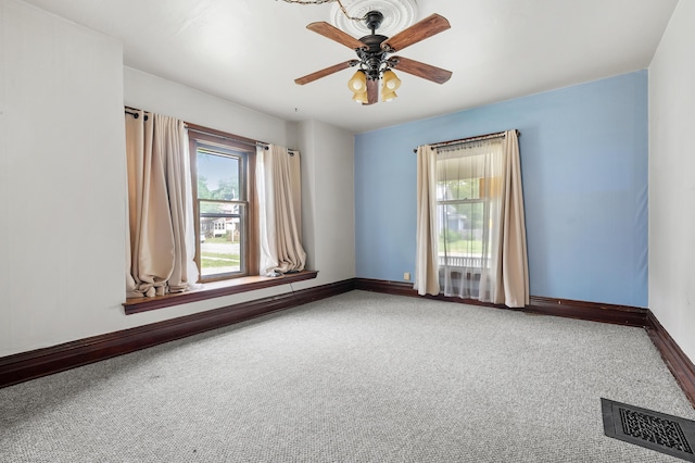 1310 Washington Ave, Kalamazoo, MI 49001 - spare room featuring healthy amount of natural light, carpet floors, and a ceiling fan