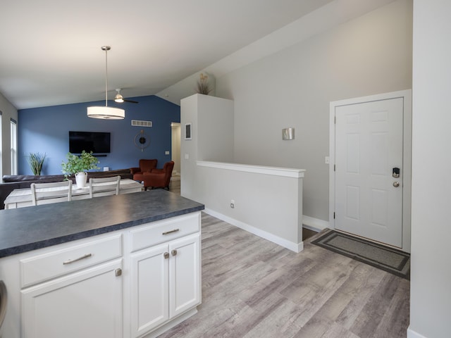 3740 Pristine Ave, Kalamazoo, MI 49048 - kitchen with lofted ceiling, dark countertops, open floor plan, ceiling fan, and light wood finished floors