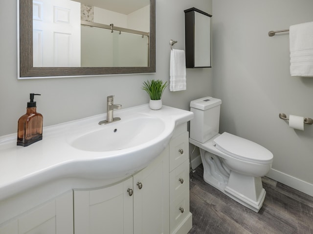 3740 Pristine Ave, Kalamazoo, MI 49048 - bathroom featuring wood finished floors, vanity, and a shower with door