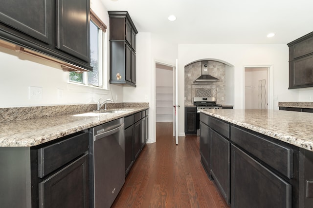 4215 Chandi Ct, Ypsilanti, MI 48197 - kitchen featuring stainless steel appliances, wall chimney range hood, dark wood-style floors, light stone countertops, and recessed lighting