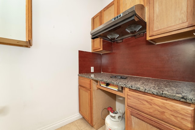 4215 Chandi Ct, Ypsilanti, MI 48197 - kitchen featuring range hood, built in study area, and light tile patterned floors