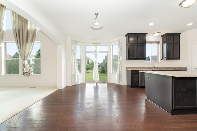 4215 Chandi Ct, Ypsilanti, MI 48197 - kitchen with dark wood-type flooring, dark brown cabinetry, recessed lighting, hanging light fixtures, and arched walkways