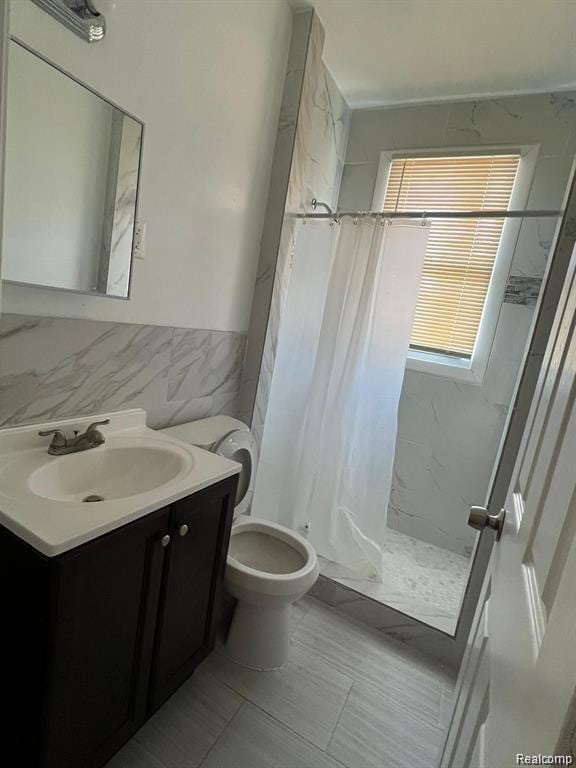 6349 Barlum St, Detroit, MI 48210 - full bathroom featuring tile walls, vanity, a stall shower, and wainscoting