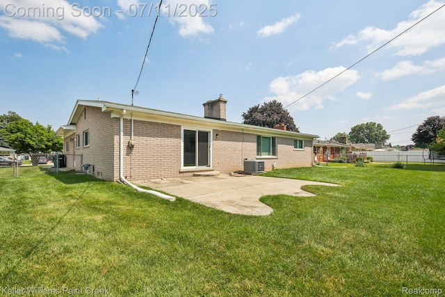 36819 Maas Dr, Sterling Heights, MI 48312 - back of house with a chimney, brick siding, and a patio