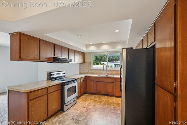 36819 Maas Dr, Sterling Heights, MI 48312 - kitchen with stainless steel appliances, exhaust hood, brown cabinets, decorative backsplash, and light countertops