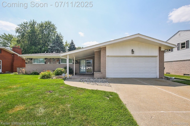 36819 Maas Dr, Sterling Heights, MI 48312 - view of front of home featuring brick siding, an attached garage, a front yard, and concrete driveway