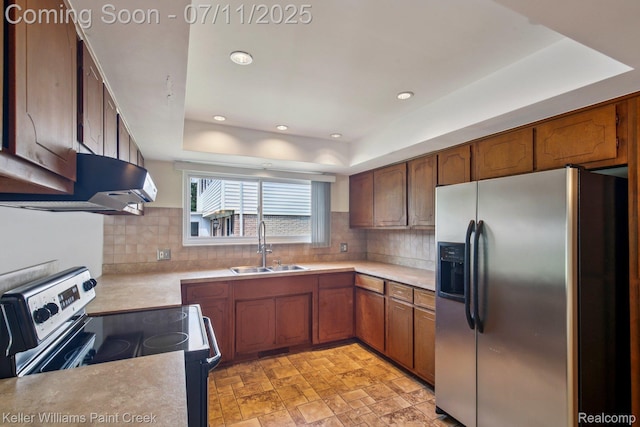 36819 Maas Dr, Sterling Heights, MI 48312 - kitchen featuring stainless steel appliances, exhaust hood, light countertops, tasteful backsplash, and a tray ceiling
