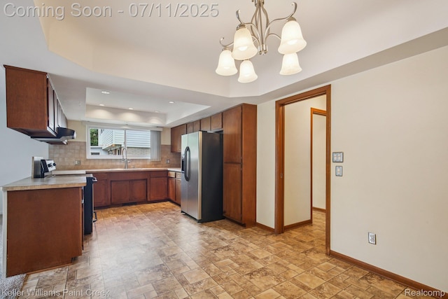 36819 Maas Dr, Sterling Heights, MI 48312 - kitchen with stainless steel refrigerator with ice dispenser, electric range oven, a tray ceiling, decorative backsplash, and light countertops