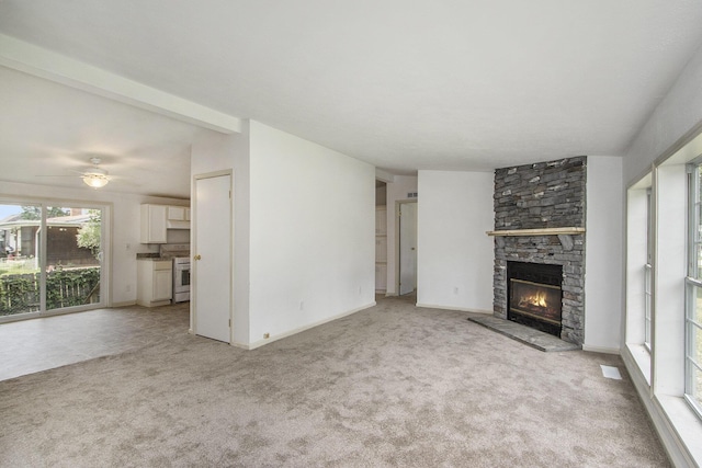 13114 Brockway Blvd, Vicksburg, MI 49097 - unfurnished living room featuring light carpet, a stone fireplace, a ceiling fan, and lofted ceiling