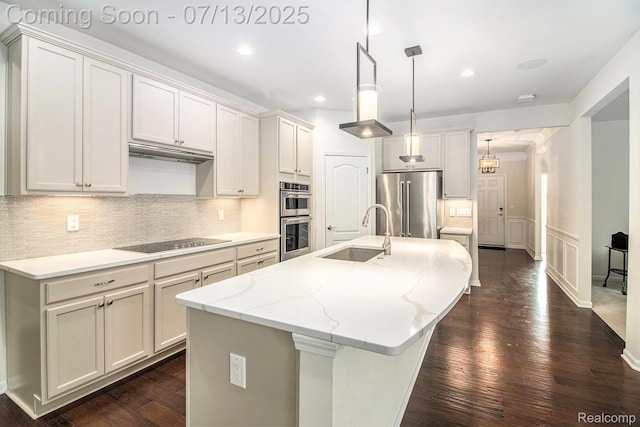 4104 Ashdale Way, Clarkston, MI 48348 - kitchen featuring appliances with stainless steel finishes, backsplash, a kitchen island with sink, dark wood-type flooring, and recessed lighting