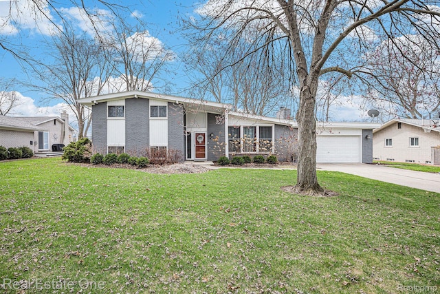 8477 Church Rd, Grosse Ile, MI 48138 - mid-century inspired home featuring concrete driveway, a garage, a front yard, and brick siding