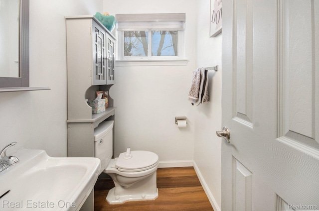 8477 Church Rd, Grosse Ile, MI 48138 - bathroom with toilet and wood finished floors