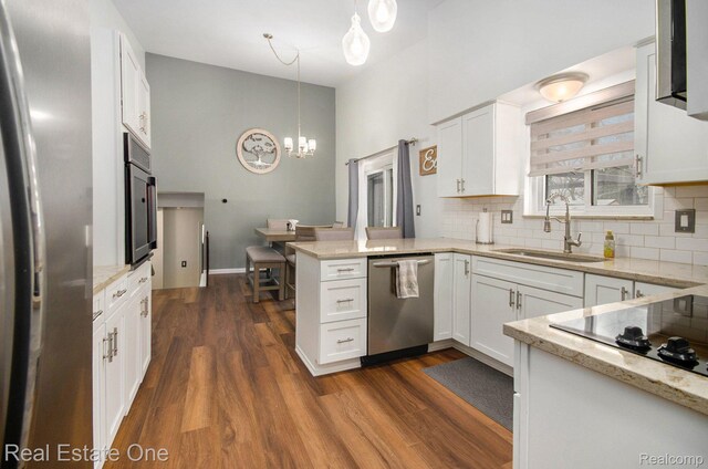 8477 Church Rd, Grosse Ile, MI 48138 - kitchen with appliances with stainless steel finishes, a peninsula, decorative backsplash, white cabinetry, and dark wood-type flooring