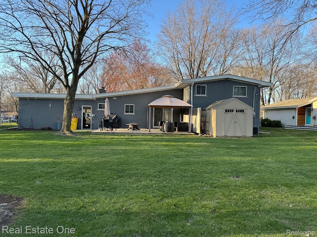 8477 Church Rd, Grosse Ile, MI 48138 - back of house featuring a lawn, a gazebo, a shed, and a patio