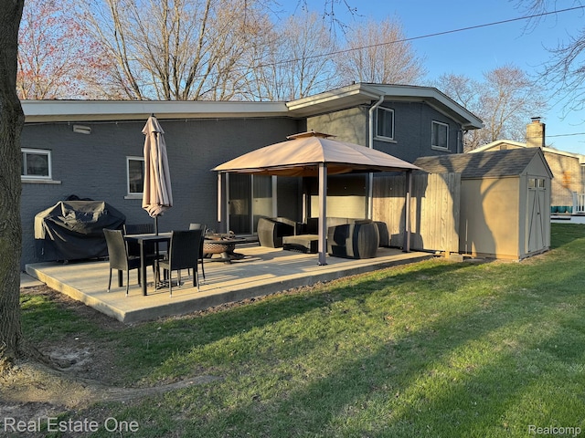 8477 Church Rd, Grosse Ile, MI 48138 - back of house featuring a yard, a patio, and a storage unit