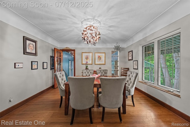 115 Illinois Ave, Pontiac, MI 48341 - dining area featuring a chandelier and wood finished floors