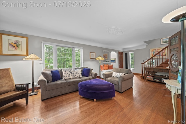 115 Illinois Ave, Pontiac, MI 48341 - living area featuring wood finished floors, stairs, and arched walkways