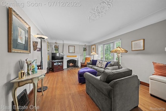 115 Illinois Ave, Pontiac, MI 48341 - living room featuring wood finished floors and a fireplace with flush hearth