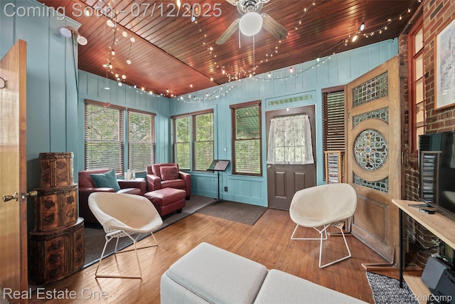 115 Illinois Ave, Pontiac, MI 48341 - living room featuring wooden ceiling, hardwood / wood-style flooring, ceiling fan, and a decorative wall