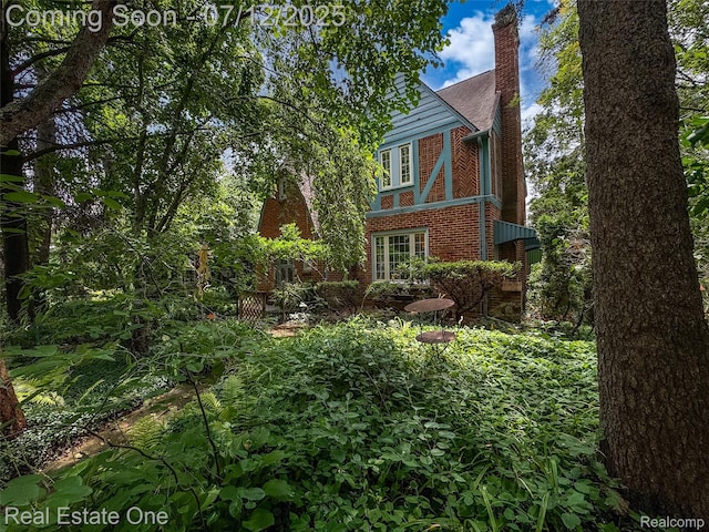 115 Illinois Ave, Pontiac, MI 48341 - view of property exterior featuring brick siding and a chimney
