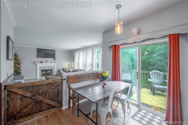 1884 Autumn Glen Dr, Howell, MI 48843 - dining area with a tiled fireplace and wood finished floors