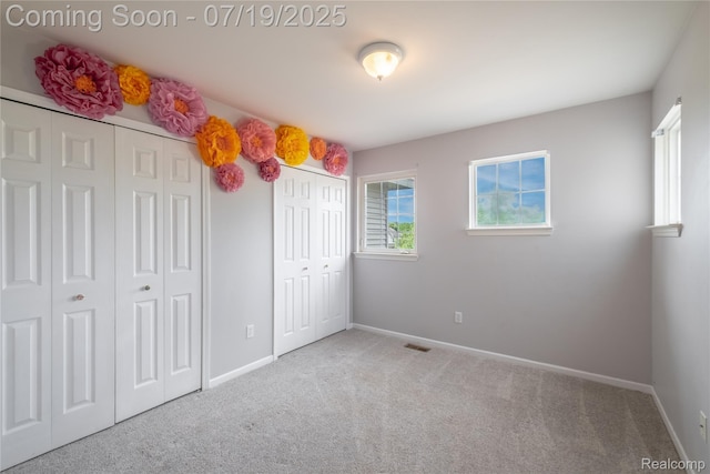 1884 Autumn Glen Dr, Howell, MI 48843 - unfurnished bedroom featuring multiple closets and carpet