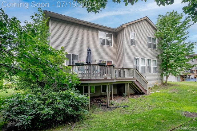 1884 Autumn Glen Dr, Howell, MI 48843 - back of property with a lawn, a wooden deck, and stairway