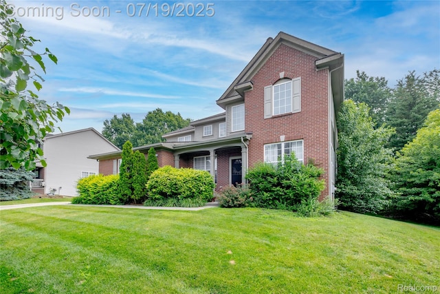 1884 Autumn Glen Dr, Howell, MI 48843 - traditional-style home featuring brick siding and a front lawn