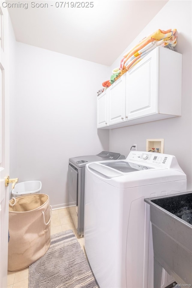1884 Autumn Glen Dr, Howell, MI 48843 - laundry room featuring cabinet space, washing machine and dryer, and light tile patterned floors