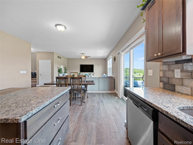 2838 Bogues View Dr, Howell, MI 48843 - kitchen with stainless steel dishwasher, ceiling fan, light wood-type flooring, tasteful backsplash, and dark brown cabinetry