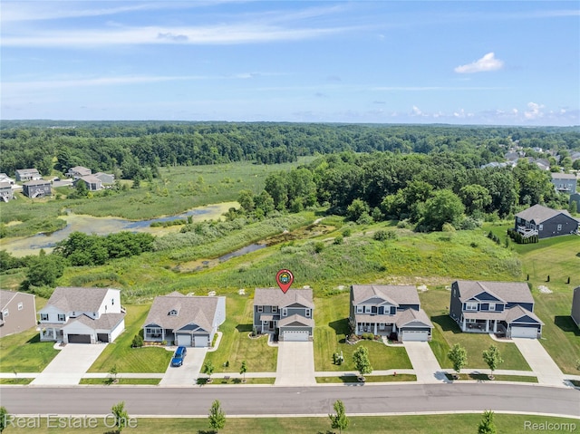 2838 Bogues View Dr, Howell, MI 48843 - aerial perspective of suburban area featuring a heavily wooded area