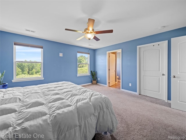 2838 Bogues View Dr, Howell, MI 48843 - bedroom with carpet, a ceiling fan, and ensuite bathroom