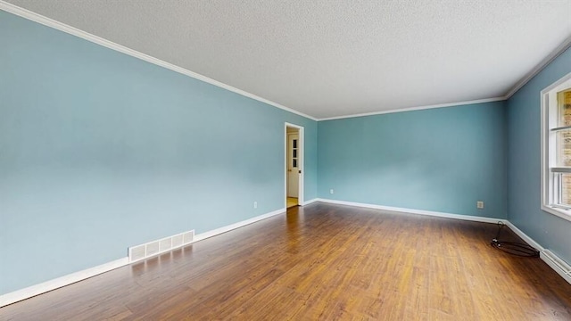 1330 Desmond St, Saint Joseph, MI 49085 - unfurnished room with wood finished floors, crown molding, and a textured ceiling