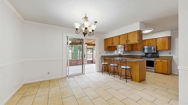 1330 Desmond St, Saint Joseph, MI 49085 - kitchen featuring stainless steel appliances, brown cabinetry, a chandelier, a peninsula, and a textured ceiling