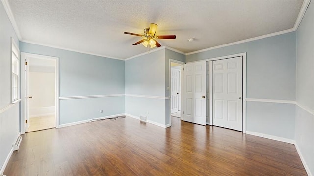 1330 Desmond St, Saint Joseph, MI 49085 - unfurnished bedroom featuring wood finished floors, crown molding, a textured ceiling, a closet, and ceiling fan