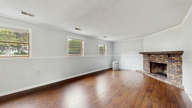 1330 Desmond St, Saint Joseph, MI 49085 - unfurnished living room featuring wood finished floors, a textured ceiling, ornamental molding, a brick fireplace, and a wainscoted wall
