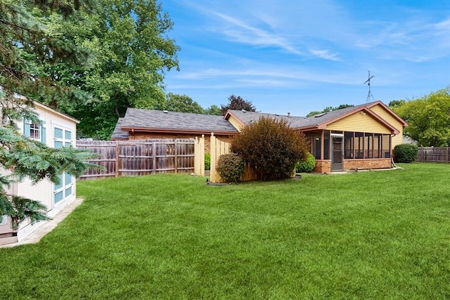 1330 Desmond St, Saint Joseph, MI 49085 - back of house with a fenced backyard, a sunroom, and brick siding