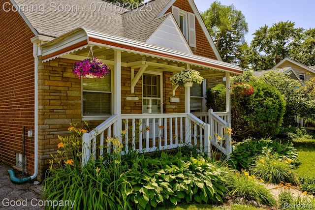 1517 W Troy St, Ferndale, MI 48220 - view of front of home with roof with shingles, brick siding, and a porch