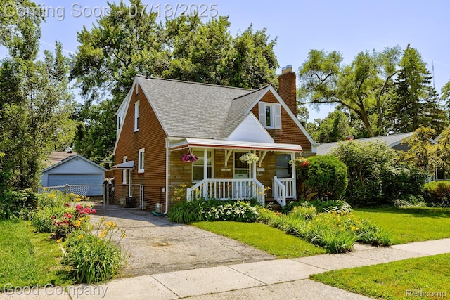 1517 W Troy St, Ferndale, MI 48220 - bungalow with a porch, a shingled roof, a front yard, a chimney, and an outbuilding