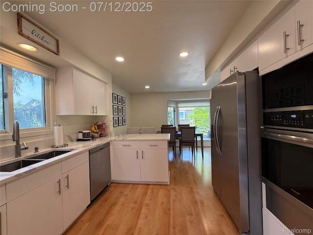 4178 Breckenridge Dr, West Bloomfield, MI 48322 - kitchen featuring stainless steel appliances, white cabinets, light wood finished floors, recessed lighting, and light countertops