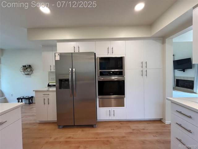 4178 Breckenridge Dr, West Bloomfield, MI 48322 - kitchen featuring stainless steel appliances, light countertops, light wood finished floors, white cabinetry, and recessed lighting
