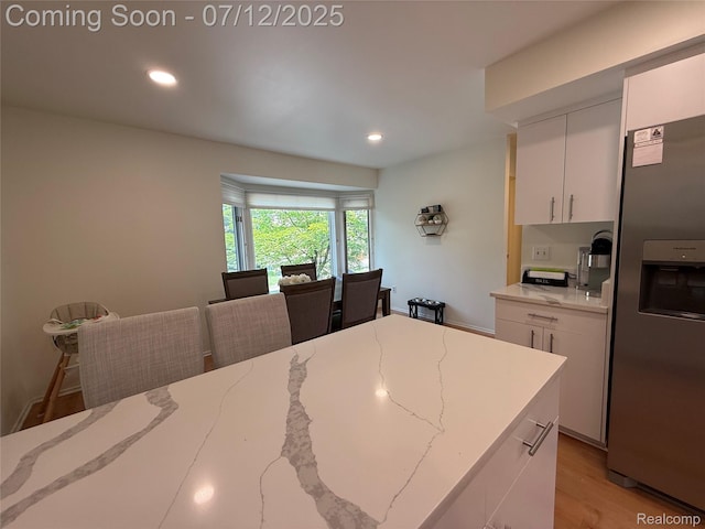 4178 Breckenridge Dr, West Bloomfield, MI 48322 - kitchen with stainless steel refrigerator with ice dispenser, white cabinetry, recessed lighting, light wood finished floors, and light stone countertops